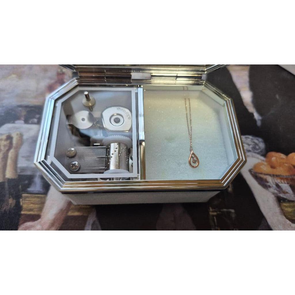Used Canal 4 necklace with music box case