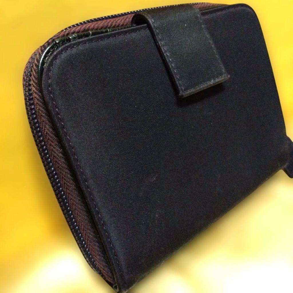 Used Excellent condition PRADA dry plum color bi-fold wallet with triangle logo plate and zipper