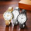 Women's waterproof and rainproof wristwatch with a round dial, large white dial, gold case, gold strap, and stainless steel quartz movement. A