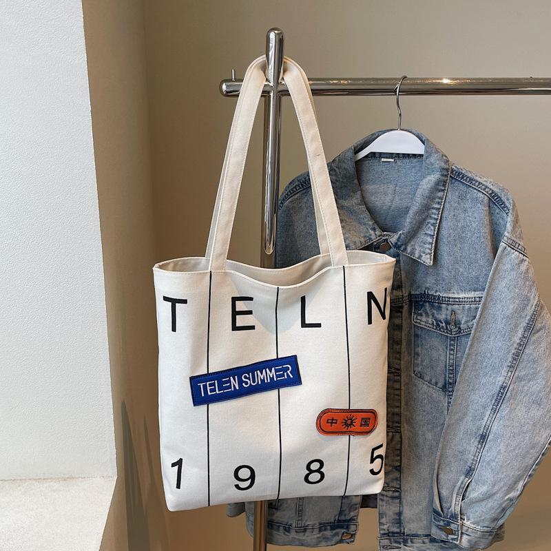 Mote Ny Myk Slitesterk Vintage Tote Stor Kapasitet Premium Tekstur Myk Slitesterk Bokstavtrykk Utendørs Pendler Enkel Skulder Crossbody Bøtteveske