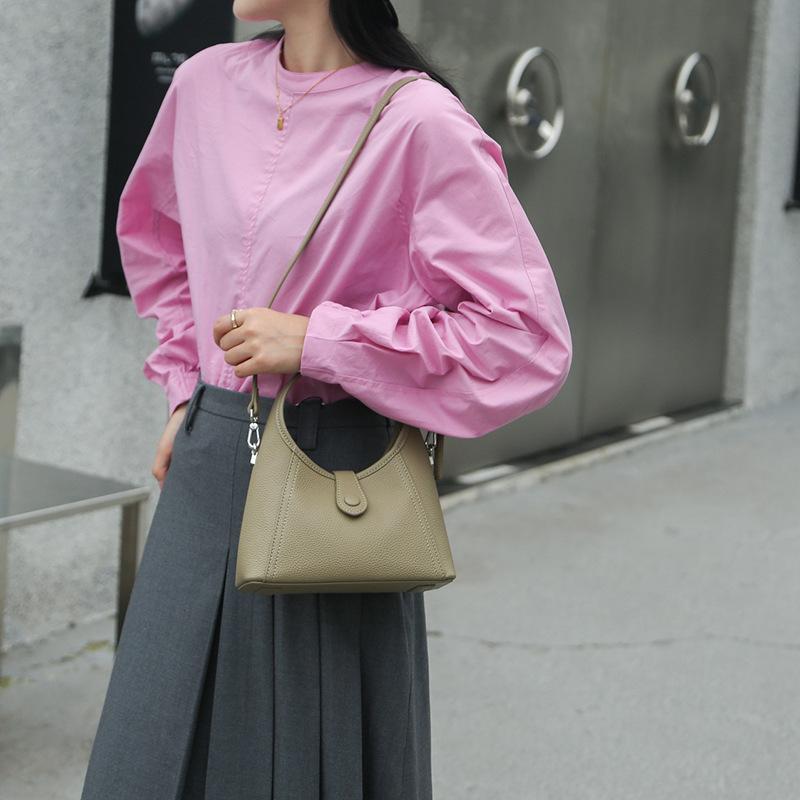 Leather women's bag semi-round moon bag niche design 2025 new cowhide shoulder crossbody armpit bag portable