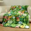 Colorful clovers and flowers scattered on a green background. for all seasons blanket lunch break throw gift