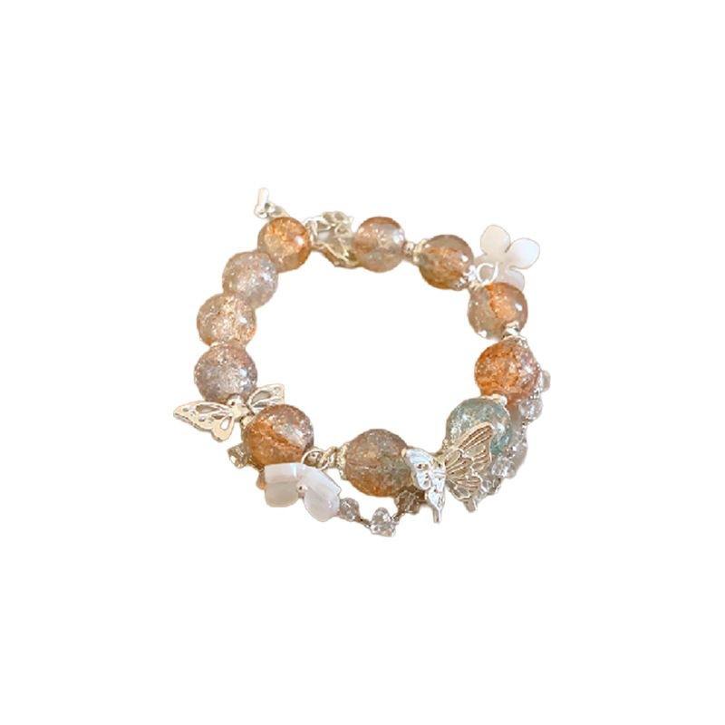 

Браслет персикового цвета со стразами и бабочкой