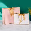 In-Stock White Cardboard Gift Bags with Bow Handle, Customizable Logo for Clothing Stores