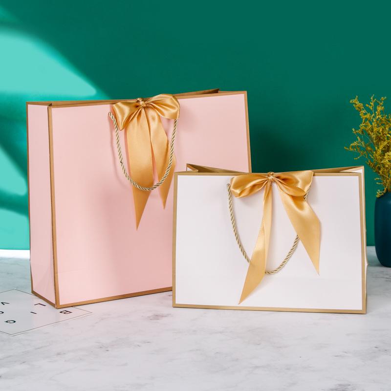 In-Stock White Cardboard Gift Bags with Bow Handle, Customizable Logo for Clothing Stores
