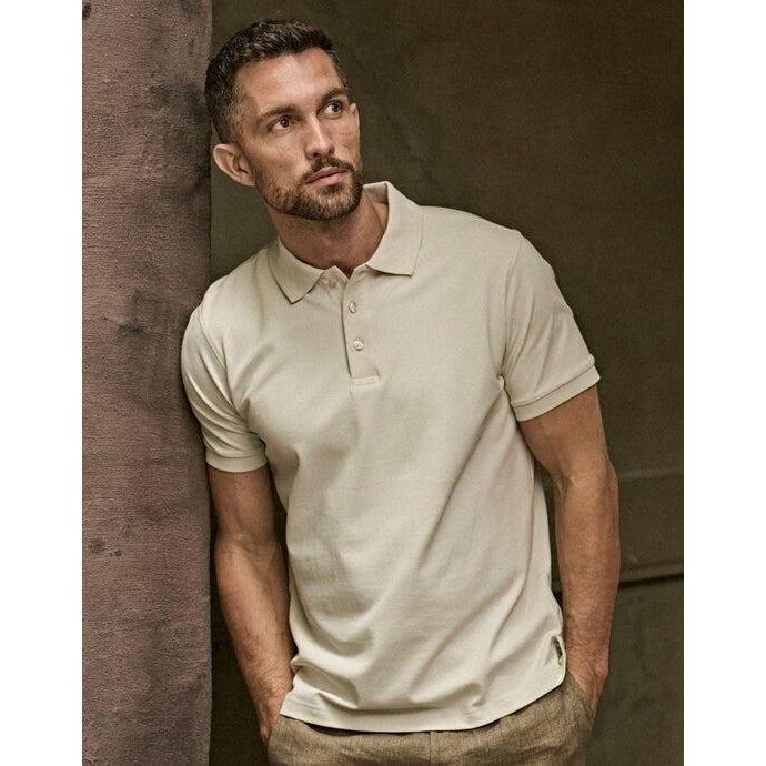 Tee Jays Polo de manga corta elástico de lujo para hombre