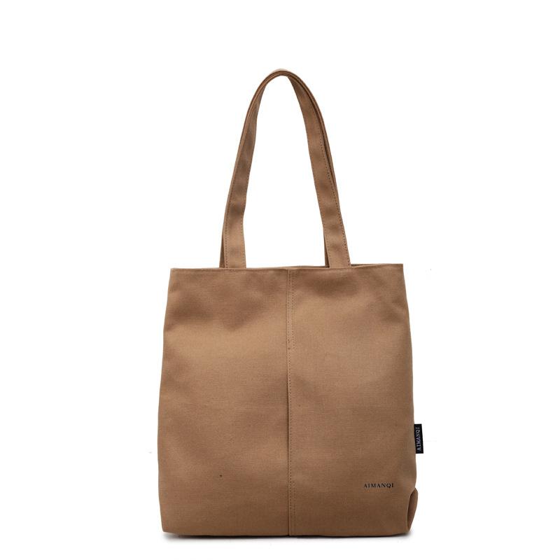 Eine modische und schlichte Umhängetasche aus Stoff mit großem Fassungsvermögen für Pendler-Studenten