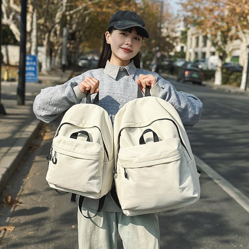 Casual large-capacity backpack fashionable outdoor lightweight junior high school students solid color simple schoolbag Korean version travel backpack