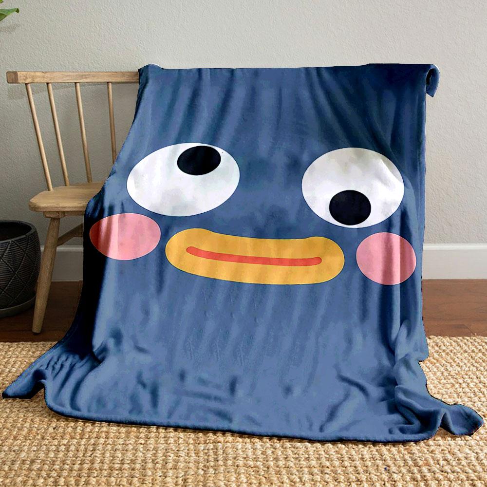 A cute cartoonish face with wide eyes, pink cheeks, and a yellow beak. for all seasons blanket lunch break throw gift