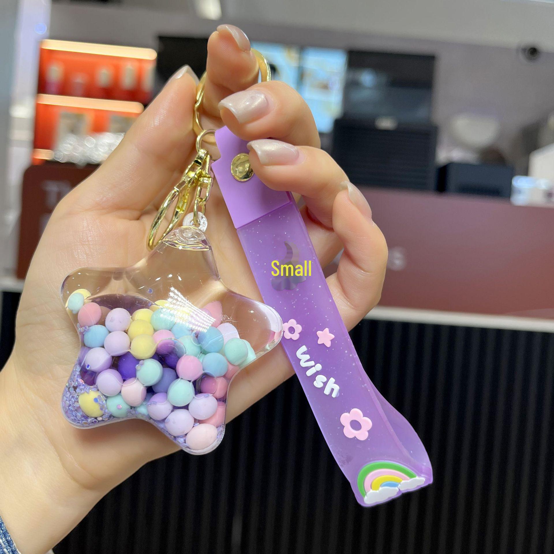 

Подвеска-брелок в виде звезды из акриловых желейных бобов с масляным наполнением в виде зыбучего песка звезда/фиолетовый