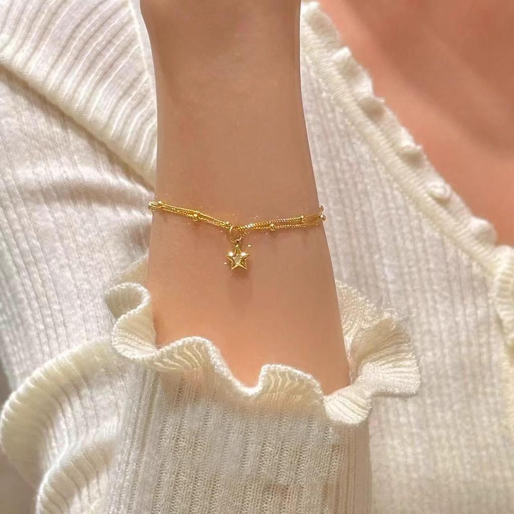 Gold Double-Layer Star Pendant Bracelet for Women - Small Wrist Design, Unique & Elegant.