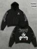 Black background, white ink, spiked death metal font, hand-held full-sleeved printed short hooded sweater, dark high street