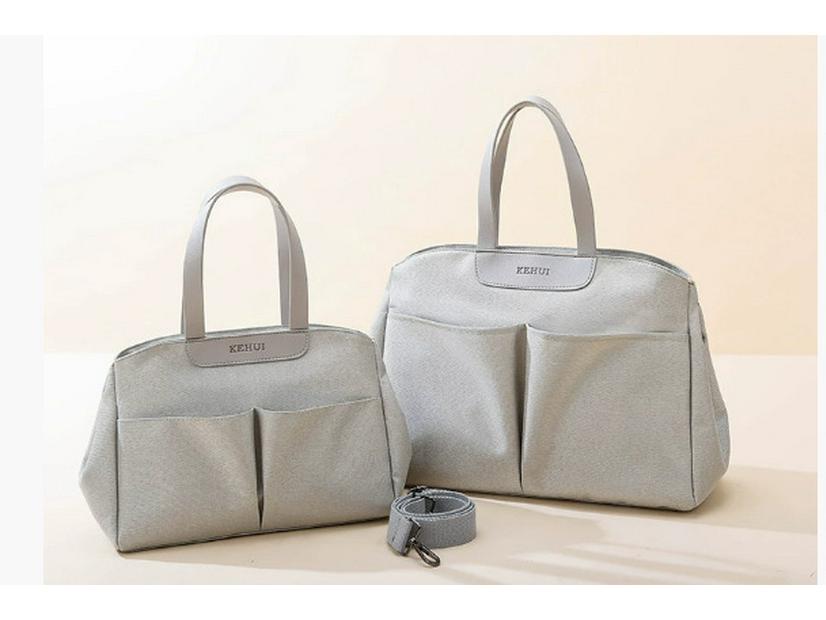 Modische multifunktionale Mamatasche: Isolierte Wickeltasche zum Tragen in der Hand, als Schultertasche oder als Messenger-Tasche für Mutter und Baby