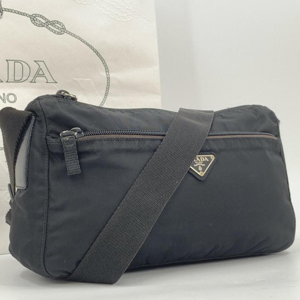 Prada Pocono Schultertasche Kameratasche Crossbody Tessuto Nylon Leder Schwarzer Schultergurt Crossbody Dreieckiges Logo-Schild Weißes Etikett