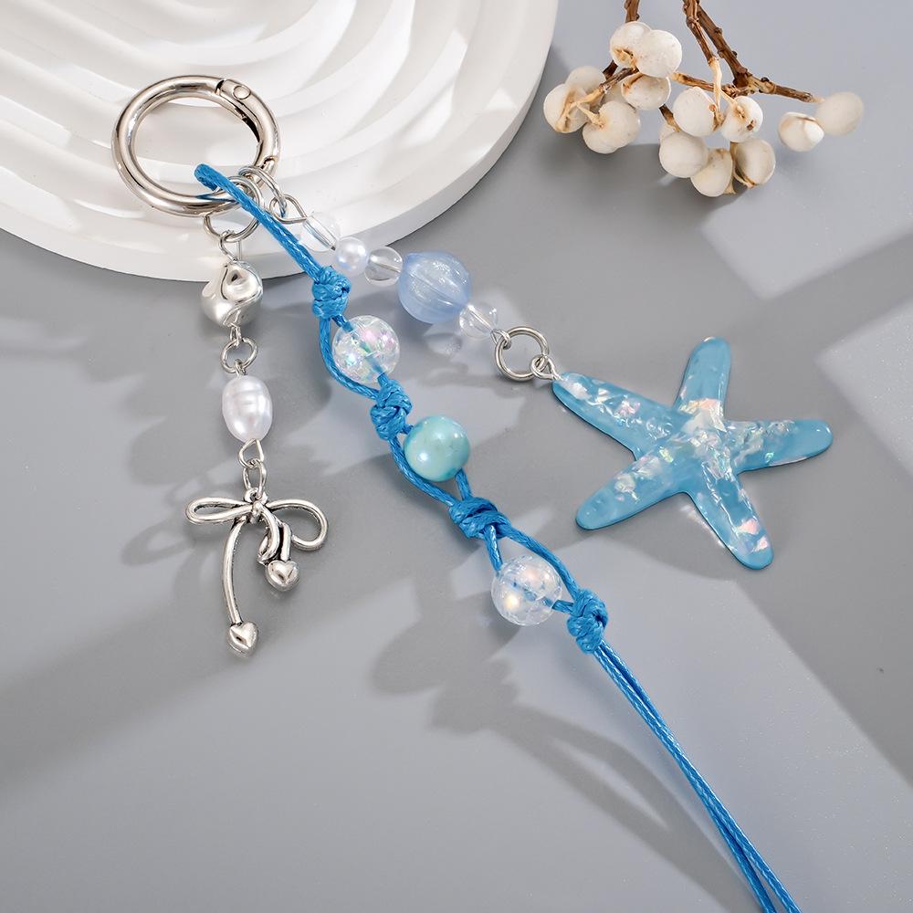

Handmade beaded woven rope pendant with colorful sequins and star-shaped design for mobile phone decoration.