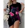 The Lovely Lady Is Holding a Cat In Her Hand, While She Is Wearing a Round-neck Short-sleeved Dress with a Floral Pattern On It.