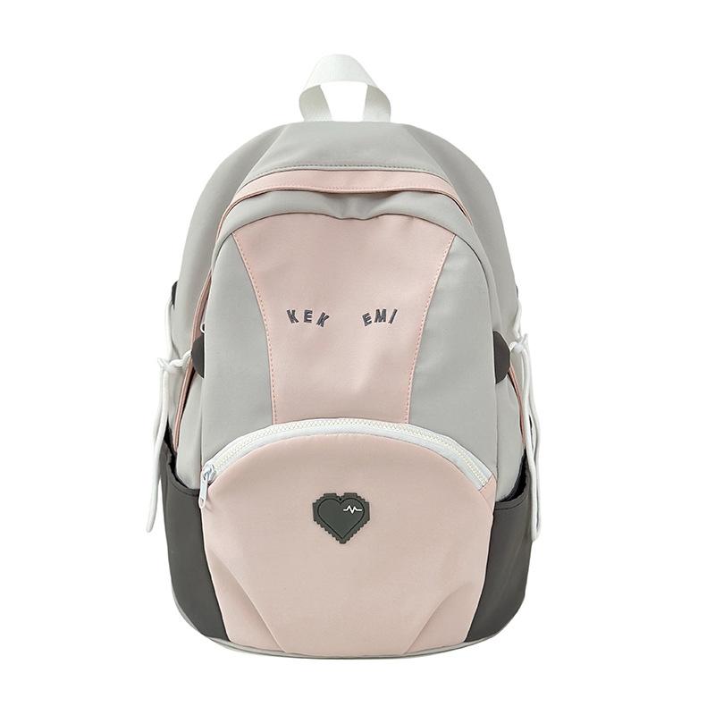 Exquisite and cute color matching large-capacity load reduction male and female student schoolbags 25 new casual size backpacks