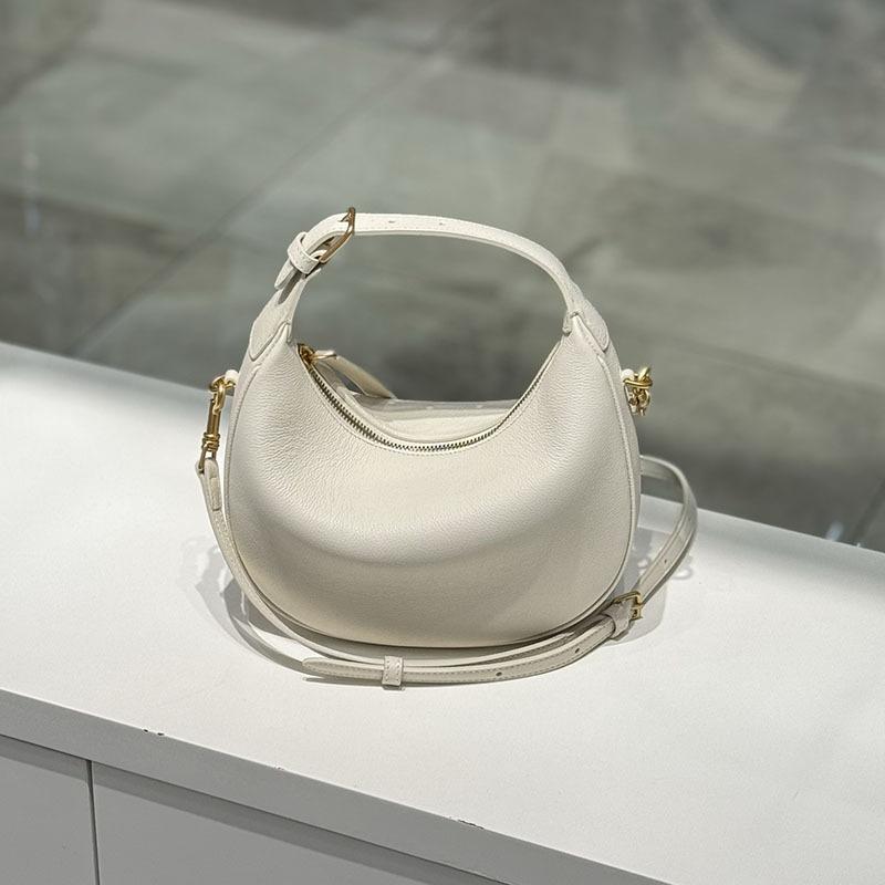 The new crescent-shaped bag, hand-held top layer cowhide women's bag, single-shoulder crossbody genuine leather underarm bag, exudes a sense of luxury