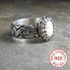 Vintage-style 925 sterling silver ring with oval moonstone and floral motif design, suitable for engagement