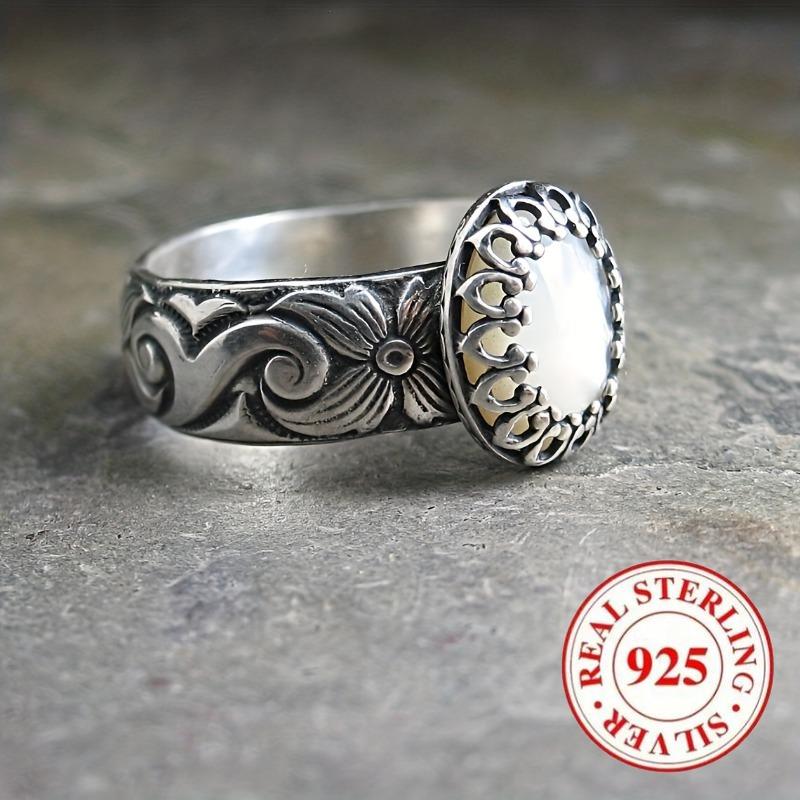 Vintage-style 925 sterling silver ring with oval moonstone and floral motif design, suitable for engagement