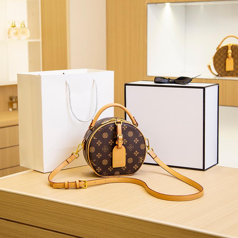 

Retro new women s bag, letter-printed portable small round bag, high-end contrasting color round cake bag, shoulder messenger bag.