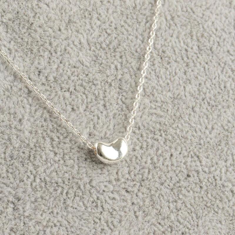 Simple bean-shaped sterling silver necklace with a thin chain