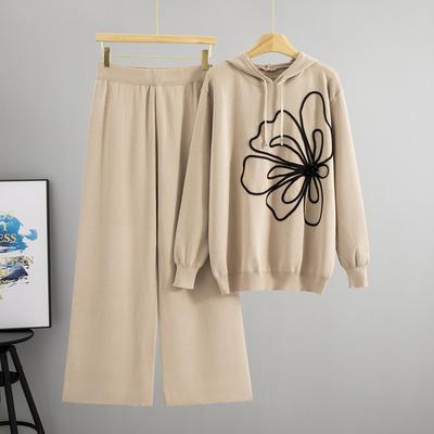 Ein modisches, schlichtes und elegantes zweiteiliges Set für Damen: Ein Pullover-Oberteil mit Kapuze und Blumenmuster und eine Hose mit weitem Bein