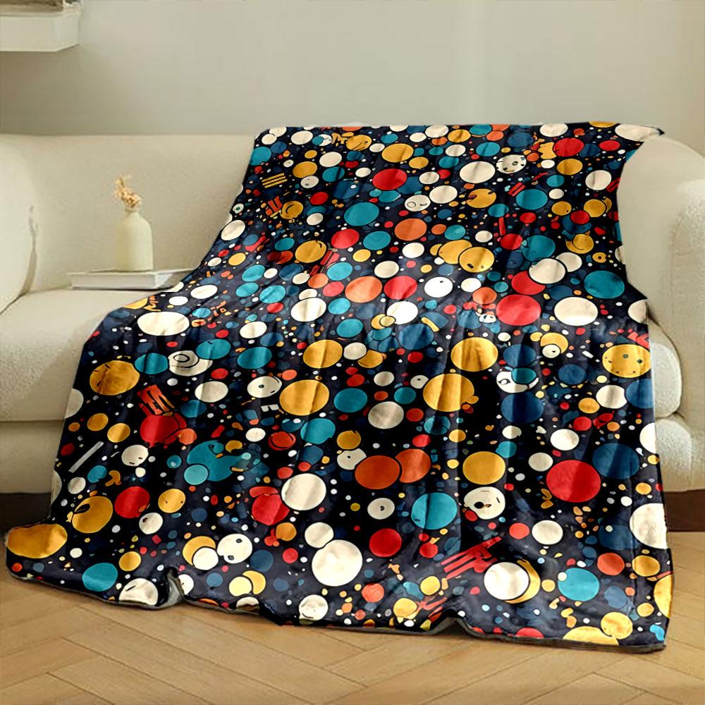 A colorful pattern of varying-sized circles with smiling faces on dark. for all seasons blanket lunch break throw gift