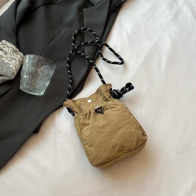 2025 New Japan and South Korea literary single shoulder messenger bag drawstring small bag niche sense fashion high value mobile phone nylon bag women