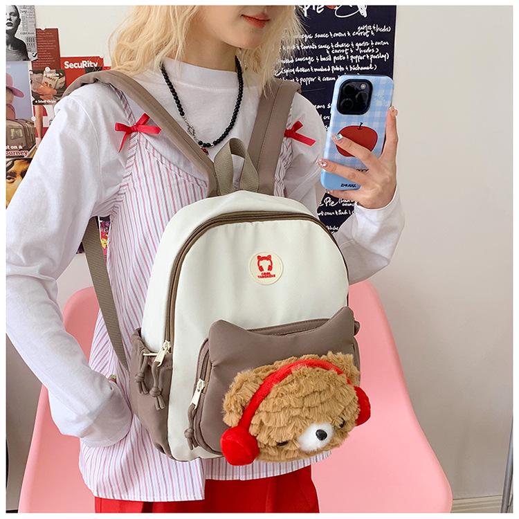 Cute Cartoon Trendy Backpack: Large Capacity, Lightweight, Versatile Travel/School Bag with Earphone and Doll Holder.