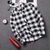 Men's Korean Style Black & White Plaid Shirt: Trendy, Loose, Long-Sleeved, Casual Top for Spring and Autumn.