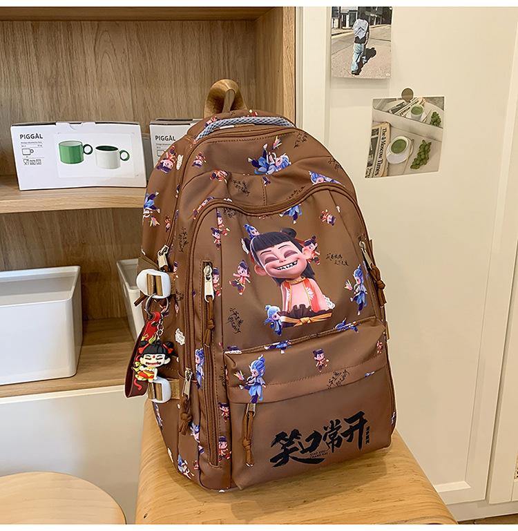 

School bags, students, boys and girls, large-capacity Nezha backpacks, lightweight and versatile, junior high school classes темно-коричневого кольору