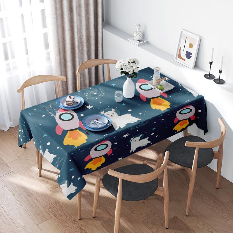 Space-themed tablecloth with rocket and polar bear design suitable for kids’ parties or home decor!