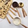 A Set of Eight Stainless Steel Measuring Cups and Wooden Handled Spoons for Kitchen Baking Tools, Measuring Tools, and Scales