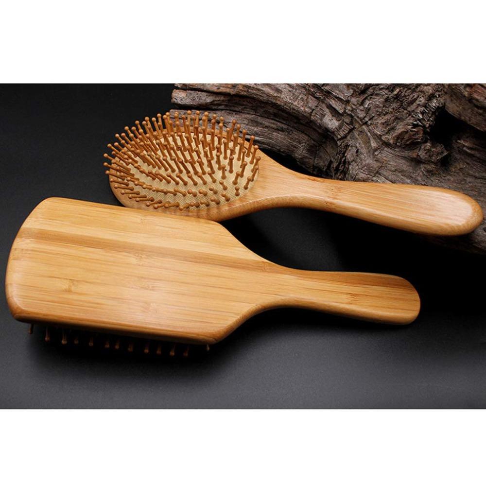 Natural wood paddle comb with bamboo bristles to detangle hair, suitable for women, men, and children, reduces frizz and massages the scalp
