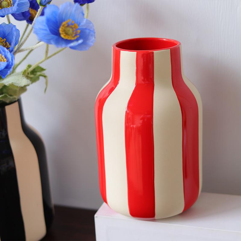 Modern minimalist ceramic vase with black and red stripes on white background vase decoration