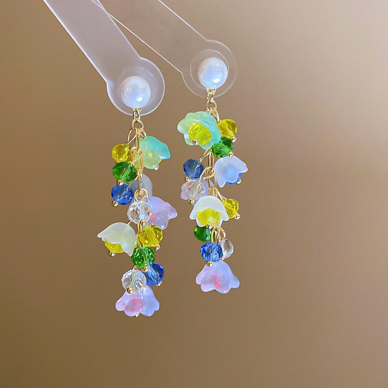 Boucles d'oreilles bohèmes roses à fleurs de perles de rocaille et pompons de perles