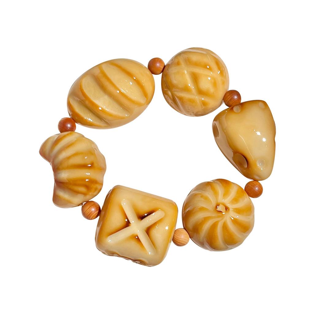 Der gleiche Stil wie der Little Red Shop: Holzkohle-gebranntes Elfenbein-Fruchtschnitzerei-Armband, süßes brotförmiges Elfenbein-Frucht-Kulturspielzeug-Armband für