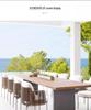 Outdoor Rattan Dining Set: Long Table with Casual Woven Chairs for Garden, Terrace, or Courtyard.