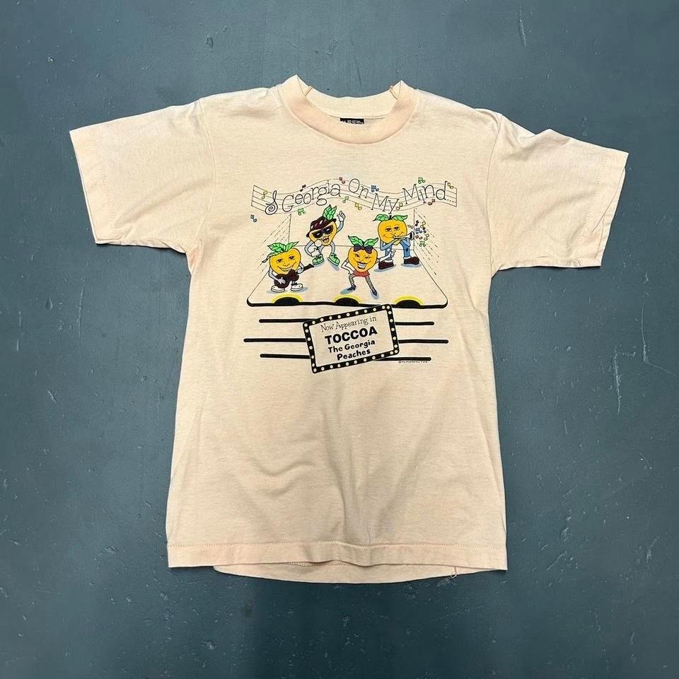

Vintage single stitch peach colored The Georgia peaches cartoon graphic Tshirt 4XL