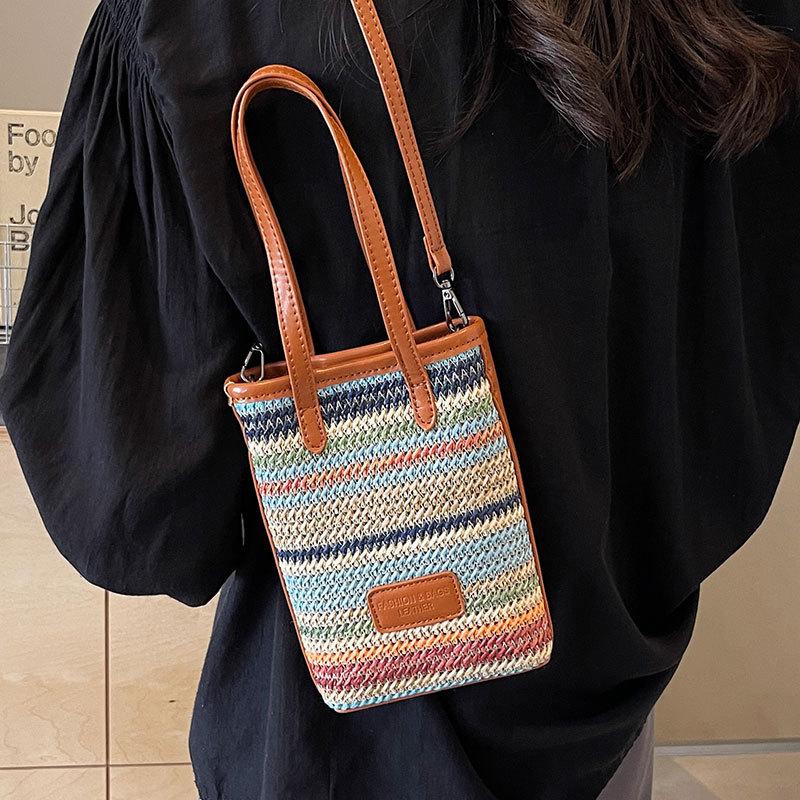 Niche lightweight versatile rainbow straw mobile phone bag spring and summer explosion leisure vacation style commuter messenger bag woman