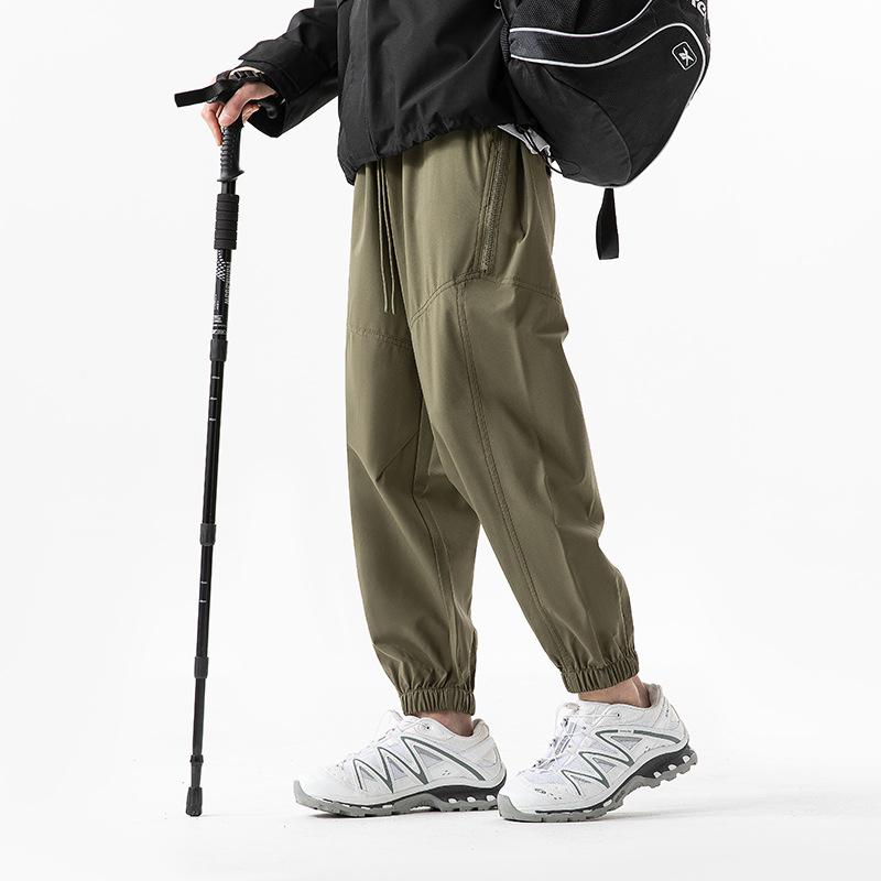Functional waterproof charging pants spring and autumn loose tied feet casual breathable sports pants outdoor mountaineering trousers