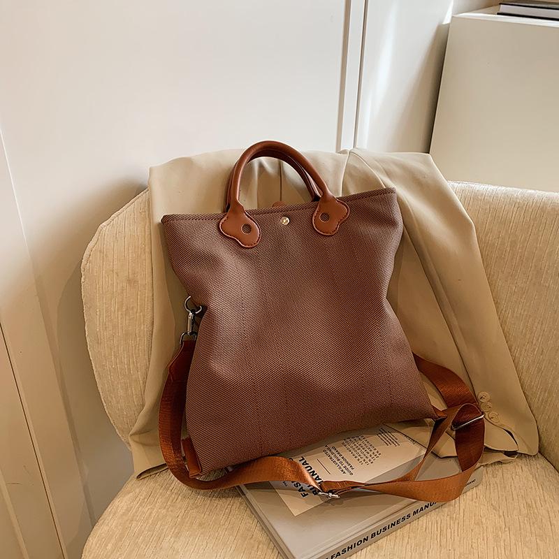 

Korean version of casual large-capacity handbag women s bag 2025 new canvas bag simple and versatile shoulder messenger bag коричневий