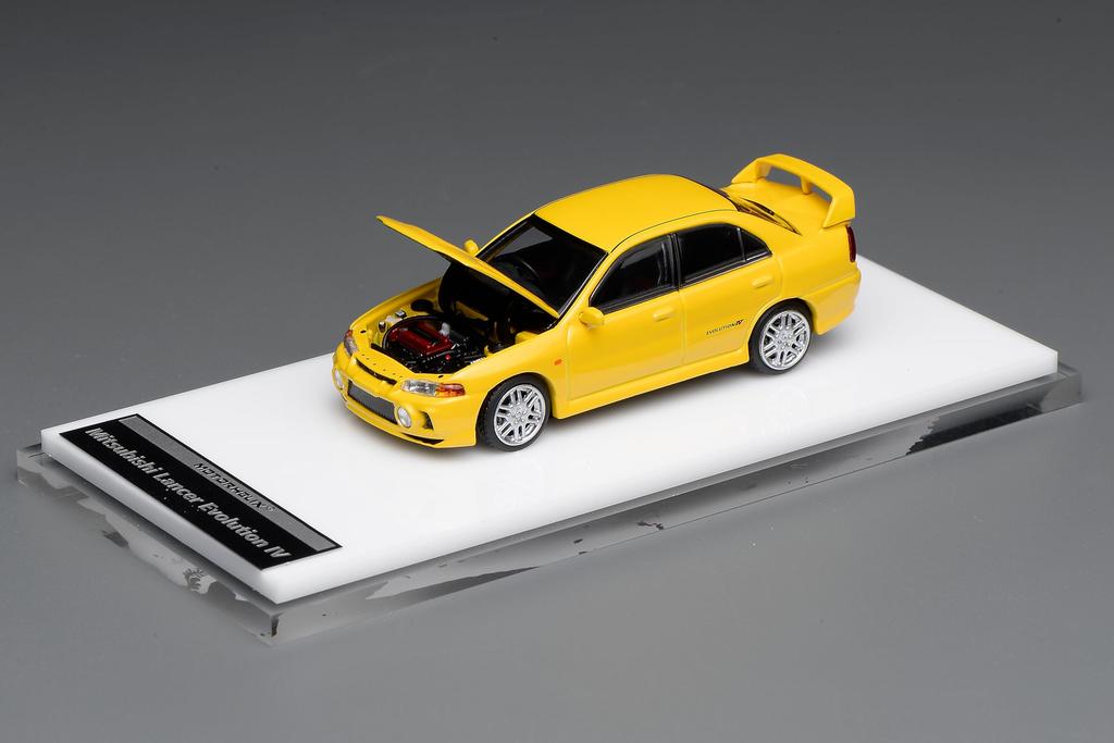 FREESTYLE MOTORHELIX Mitsubishi Lancer Evolution IV Dandelion Yellow Finished Model M64007 1/64