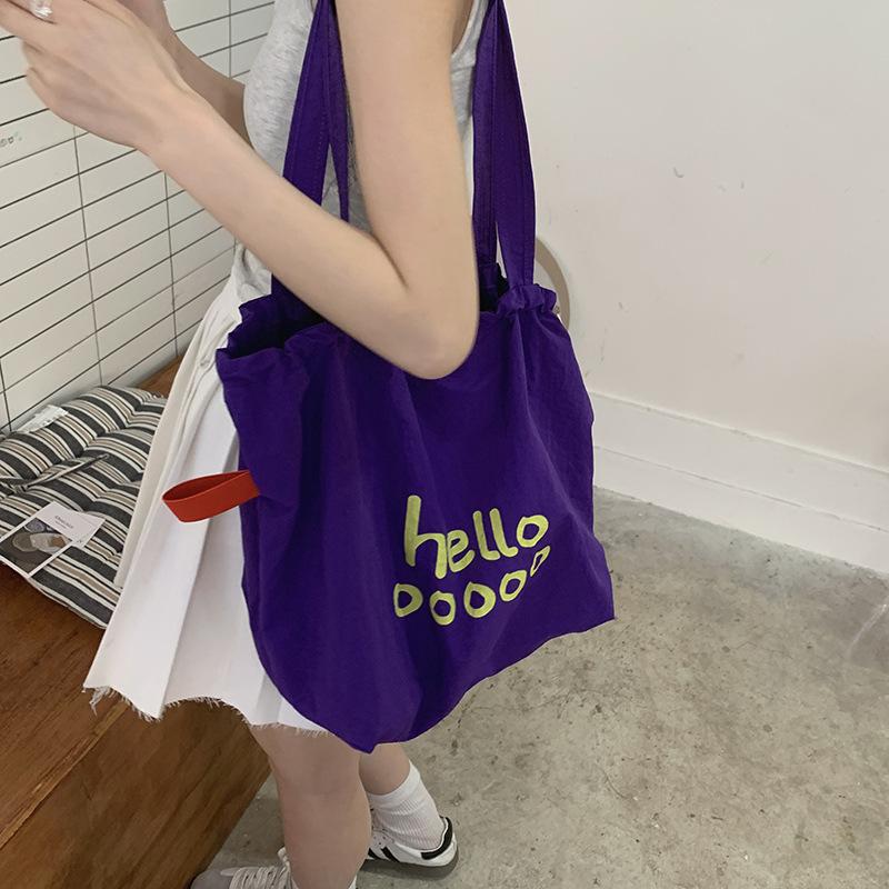 

Casual large capacity letter print canvas bag women s 2025 new simple lazy style armpit bag shoulder tote bag фіолетовий