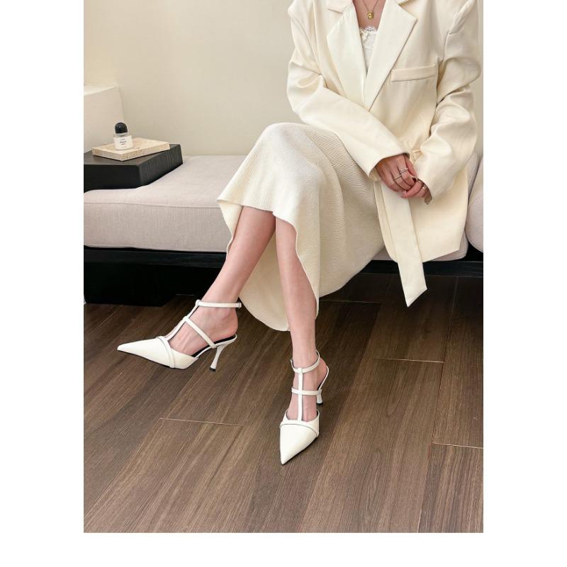 A Woman In Large-sized Pointed, Hollowed-out High-heeled Sandals