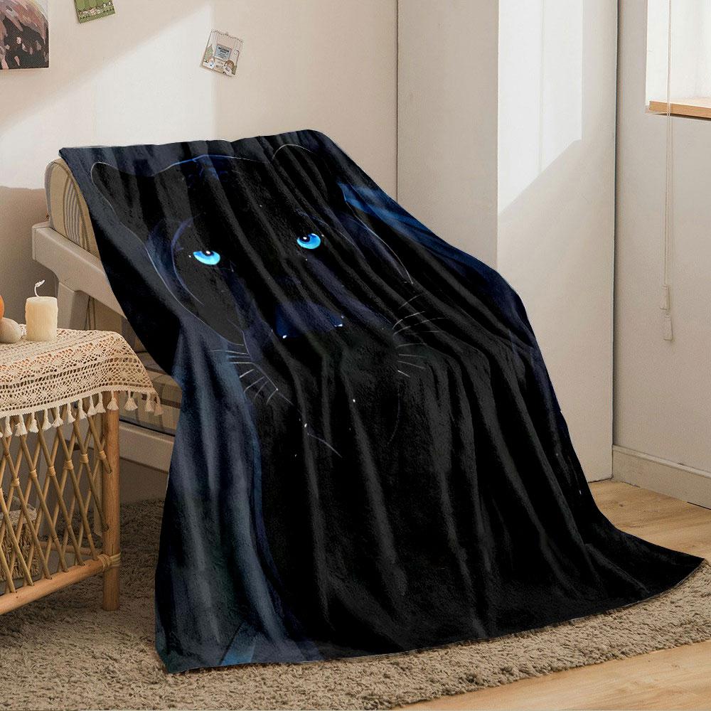 A sleek black panther with glowing blue eyes in a dark background. for all seasons blanket lunch break throw gift