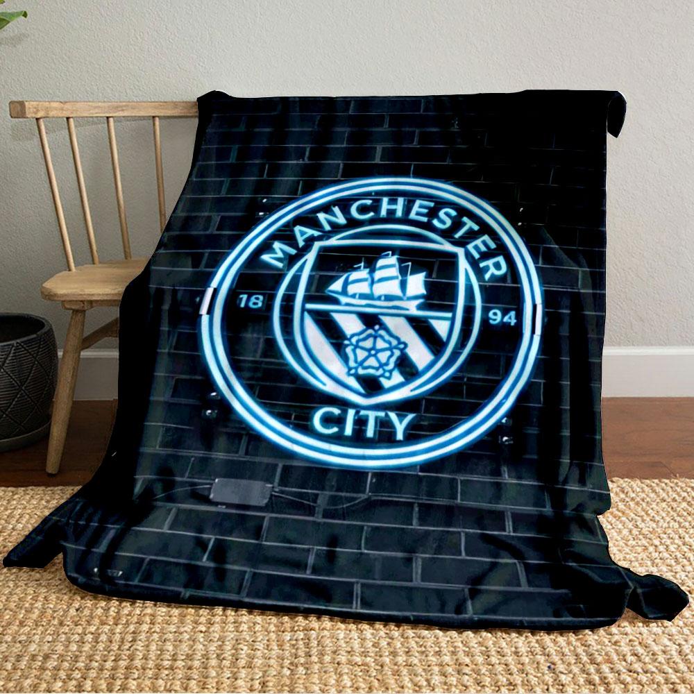 A glowing neon emblem with a ship, rose, and "Manchester City" text. for all seasons blanket lunch break throw gift
