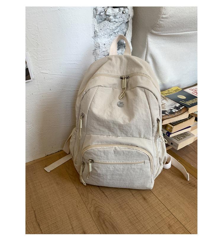 

Ultra-light schoolbag waterproof and lightweight nylon cloth large-capacity backpack new student leisure travel bag women білий