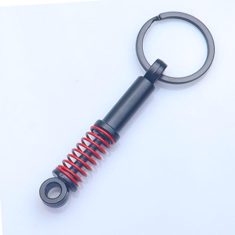 In-Stock Black Shock Absorber Keychain: Pressable Metal Spring Accessory - Perfect Small Gift